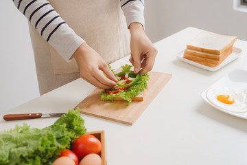 Preparing and eating breakfast at home in morning.