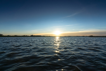 Obraz premium View from low point over the rippling water of a river