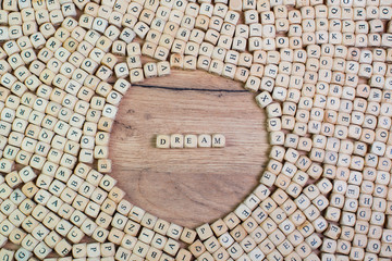 Dream name in letters on cube dices on table