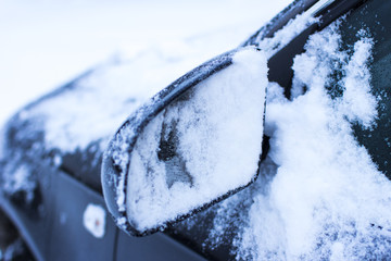 concept - close-up car mirror in the snow