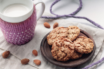Homemade oatmeal cookies and a mug of almond milk