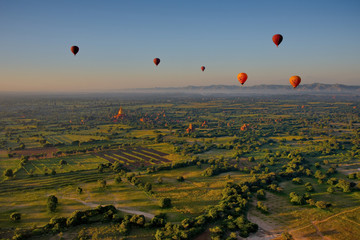 Bagan. Myanmar. 11/25/2016. Every morning at dawn, a dozen balloons carrying tourists rise together into the sky to see a bird's eye splendour of many ancient Buddhist temples of Bagan.