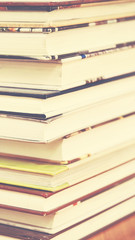 Book stack in the library room on wood desk and selective focus for business and education background, back to school concept