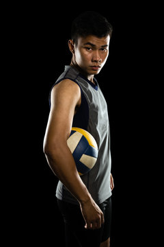 Portrait Of An Asian Professional Volleyball Player. Isolated On Black Background