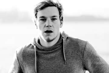 Exhausted young man in Austria after hitting the punchbag