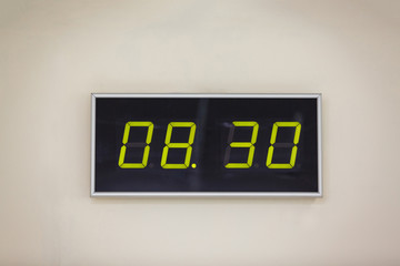 Black digital clock on a white background showing time 8 hours 30 minutes A digital alarm natural...