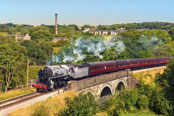 Railway bridge over river Worth near Oakworth, Yorkshire, England, UK
