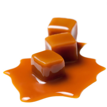 Caramel with sauce. Golden Butterscotch toffee candy caramels. Sweets  with copy space, macro.