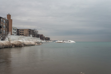 Along a frozen beach with residential buildings