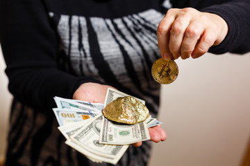 Gold nuggets with a bitcoin in the hands of the miner mining golden bitcoins