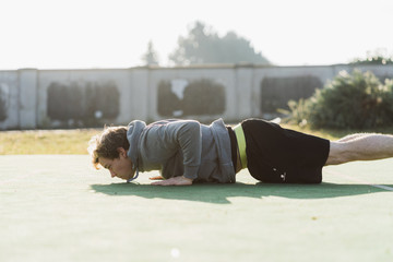 Young athlete doing burpee in Austria