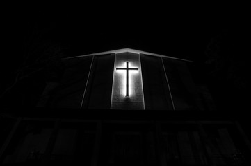 black and white lighted cross at night
