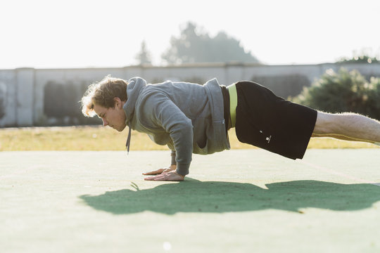 Young athlete doing burpee in Austria