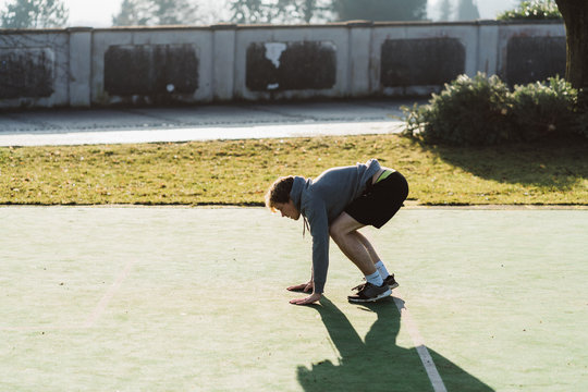 Young athlete doing burpee in Austria