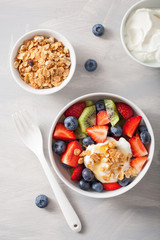 fruit berry salad with yogurt and granola for healthy breakfast