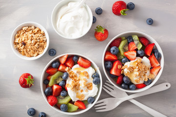 fruit berry salad with yogurt and granola for healthy breakfast