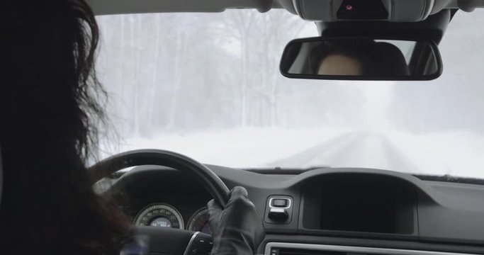 Winter Driving - woman is driving down a snowy mountain road - sequence of three different hand-held shots - ProRes