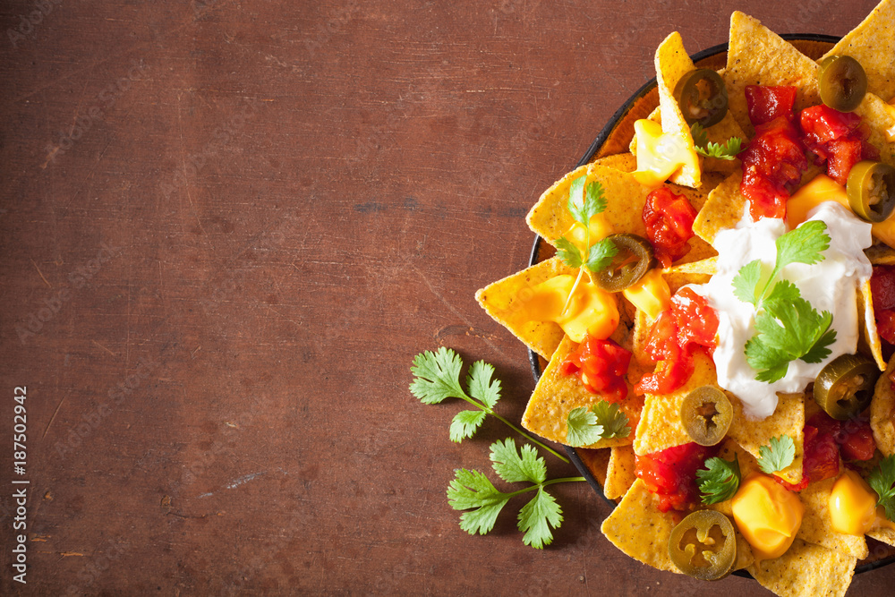 Wall mural nachos loaded with salsa, cheese and jalapeno