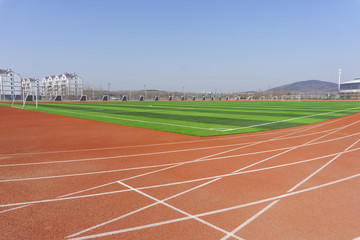 Fototapeta premium Track and field red plastic runway