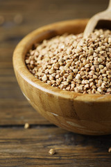 Raw buckwheat grain on the wooden table