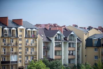 Fototapeta na wymiar Houses in residential district on blue sky background