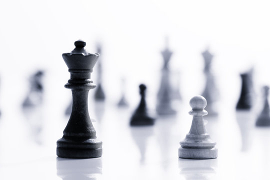 Business concept - chess - white pawn against a black king - competition