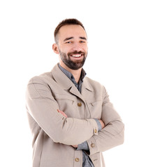 Portrait of handsome young man with crossed arms on white background