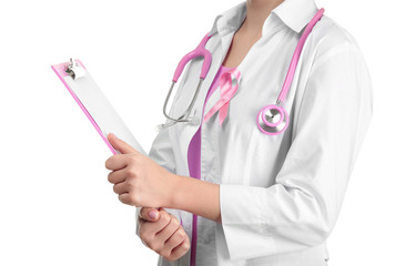 Doctor with pink ribbon on robe and clipboard against white background. Breast cancer awareness...