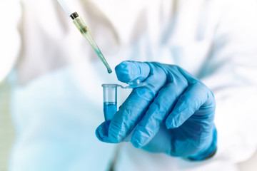 scientist pipetting medical sample in pcr tube in the laboratory / researcher with pipette and tube...