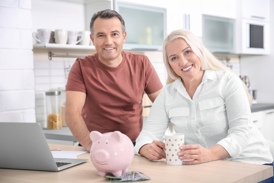 Mature Couple Managing Family Budget At Home