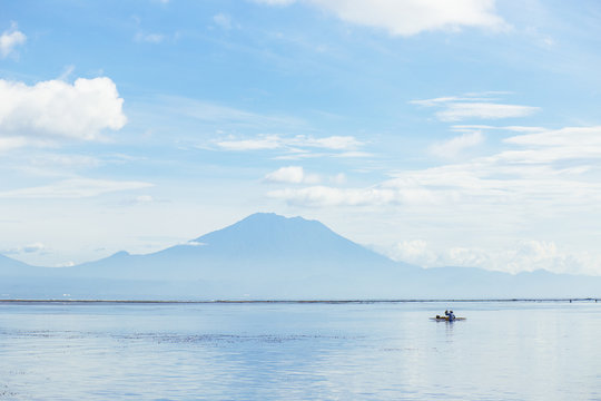 Fisherman fishing from boat in sea