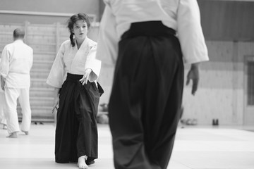 The participants of the training in special clothes of aikido hakama work out the methods of single combat