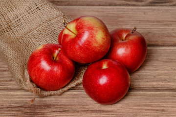 Juicy red apple on an old wooden background