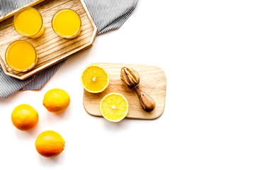 Freshly squeezed orange juice. Juicer and slices of oranges on white background top view