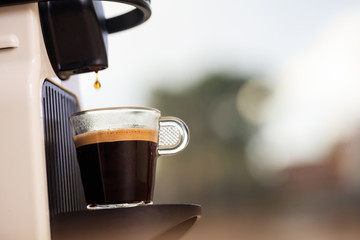 Espresso coffee machine on a blur green background, space for text