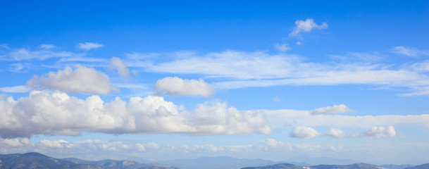 Scattered clouds on blue sky background