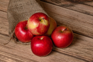 Juicy red apple on an old wooden background
