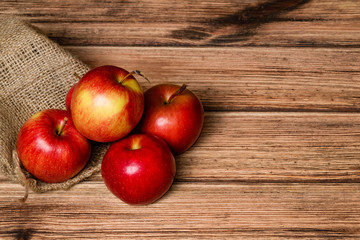 Juicy red apple on an old wooden background