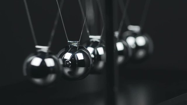 Slow motion shot of a Newton's Cradle.