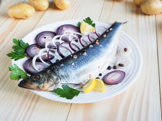 Appetizing salted herring on the plate.
