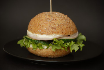 Homemade Burger on Dark Surface. Ideal for advertisement. Close-up Food Photography. Isolated.