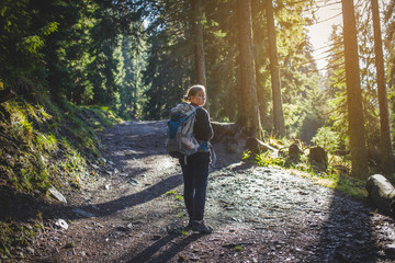 Fototapeta premium Teen Hiker Walks in Forest