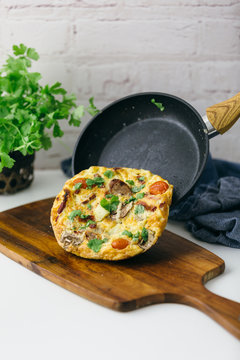 Tipping out a frittata onto a board from skillet