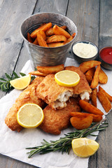 traditional British fish and chips with potato and lemon