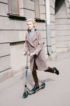 Young woman going on a scooter