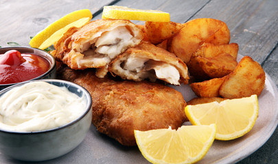 traditional British fish and chips with potato and lemon