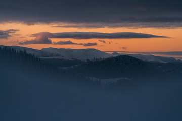 Beautiful sunrise light over the peaks, winter landscape 