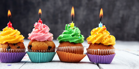 Tasty cupcakes on wooden background. Birthday cupcake in rainbow colors