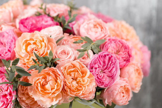 Fototapeta beautiful bouquet of mixed flowers in a box on wooden table. the work of the florist at a flower shop