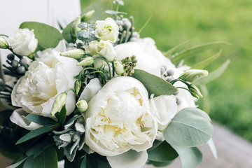 wedding bouquet with rain drops. Morning at wedding day at summer. Beautiful mix white peonies and eucalyptus